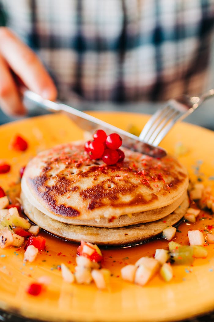 Mastering the First Impression: Your intriguing post title goes here Close-up of pancakes topped with syrup and fresh fruit, perfect for breakfast.