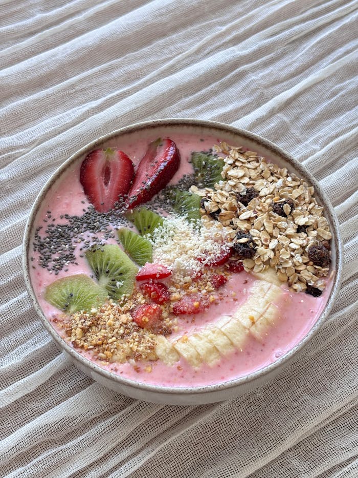 contact-img Colorful smoothie bowl with fresh fruits, chia seeds, and granola, perfect for a healthy breakfast.
