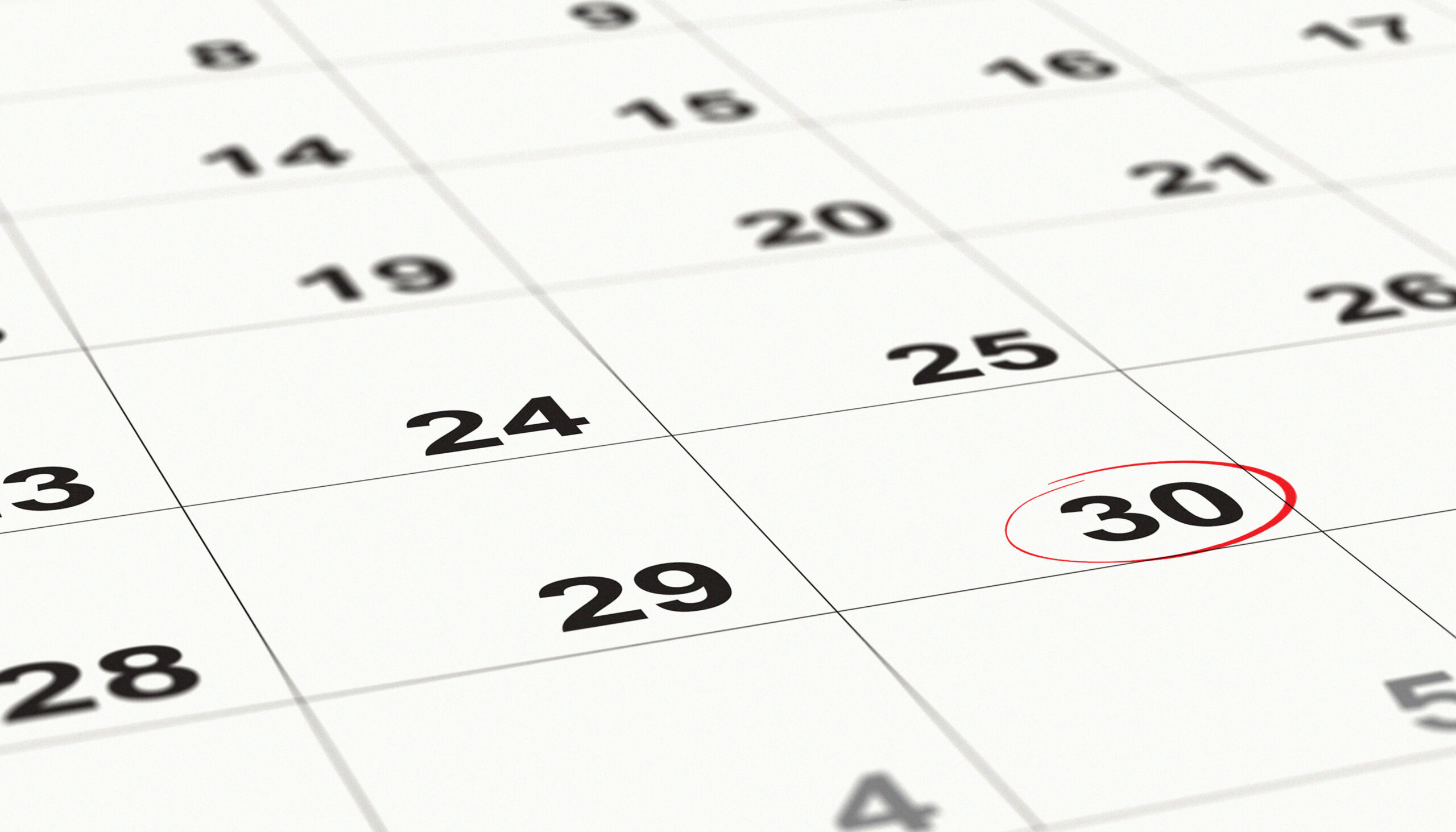 close up a date 30 with red circles on a calendar (end of the month). selective focus